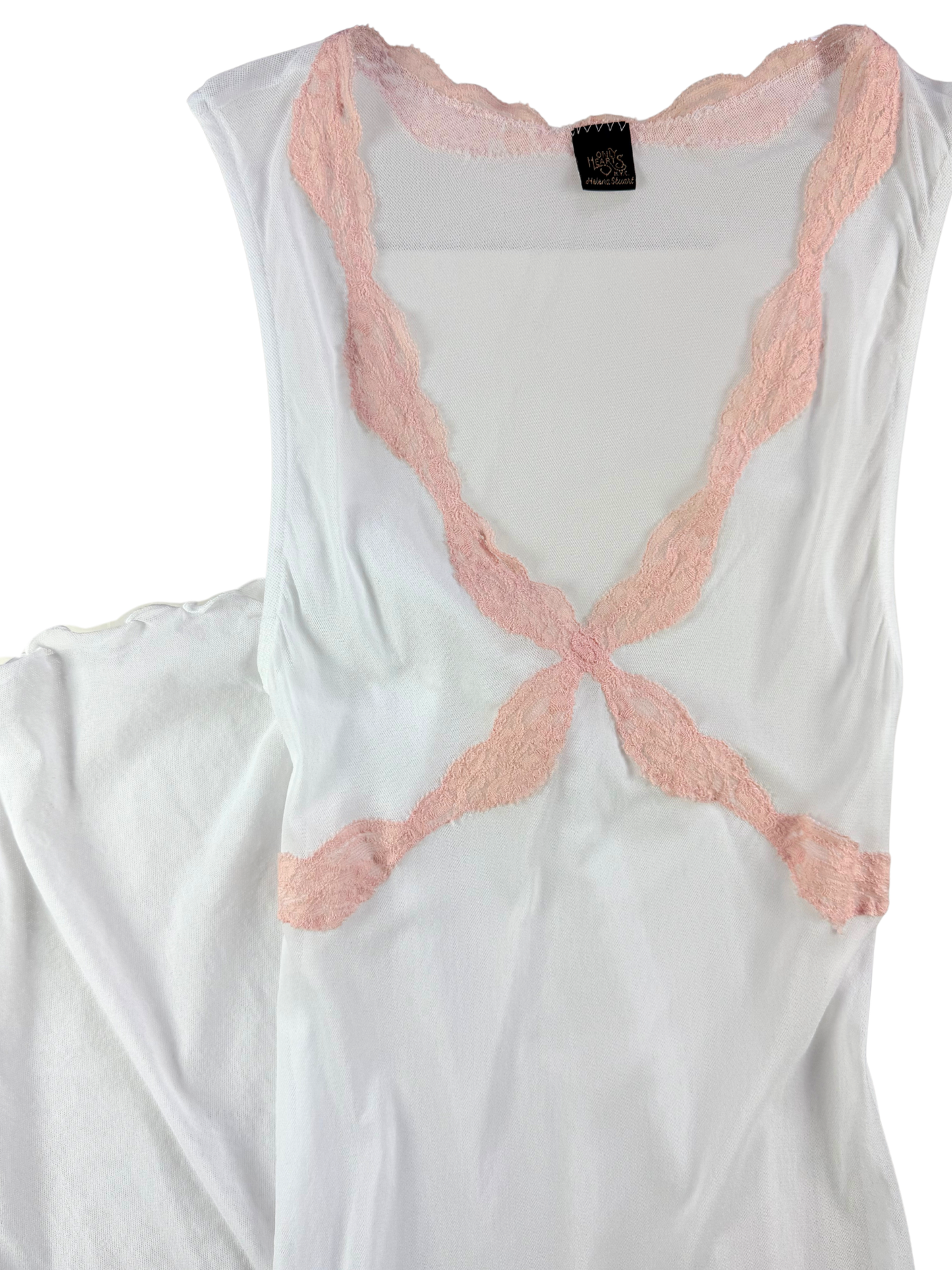 White sleeveless top with pink lace details on a white background