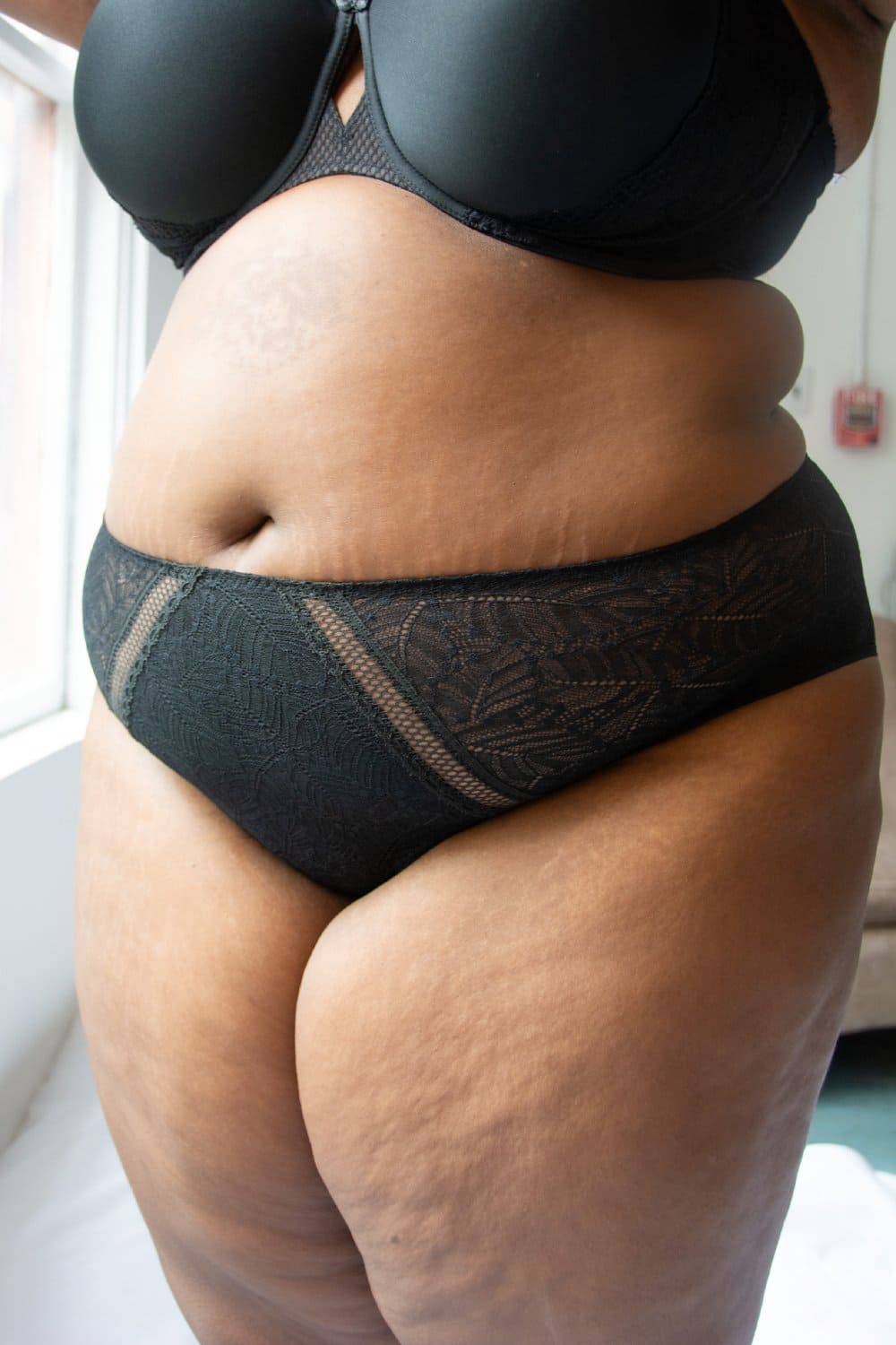 Simone Perele Comete culotte high-rise in black, front-side view on a model, large size product.