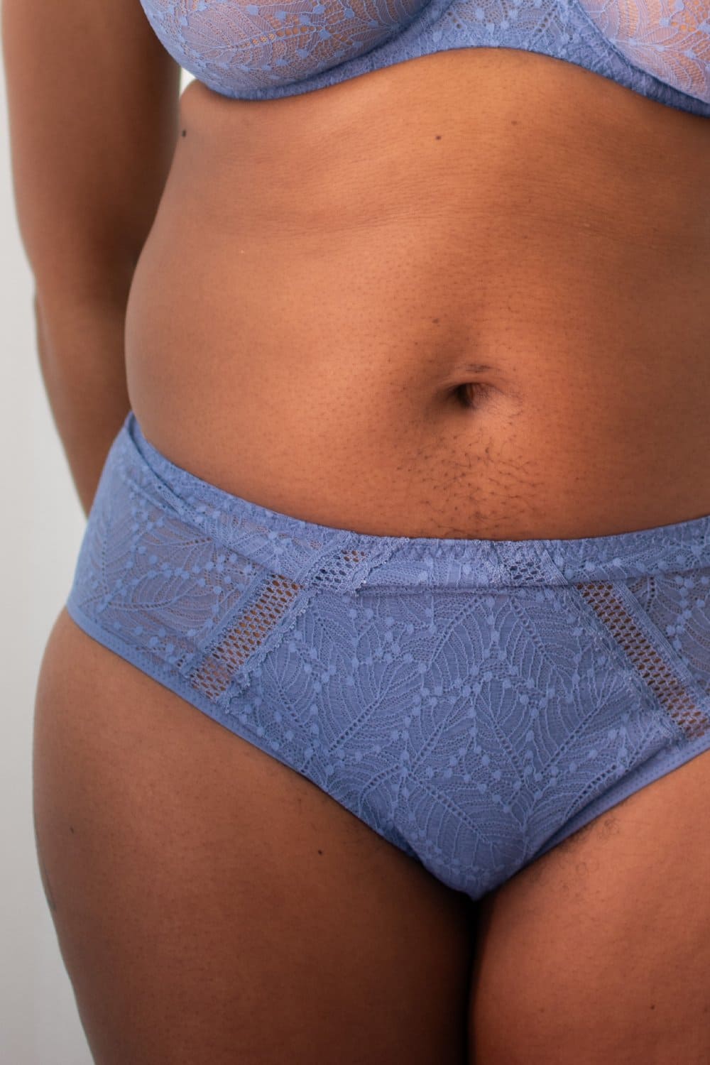Simone Perele Comete culotte high-rise in blue chambray, front view on a model, close-up.