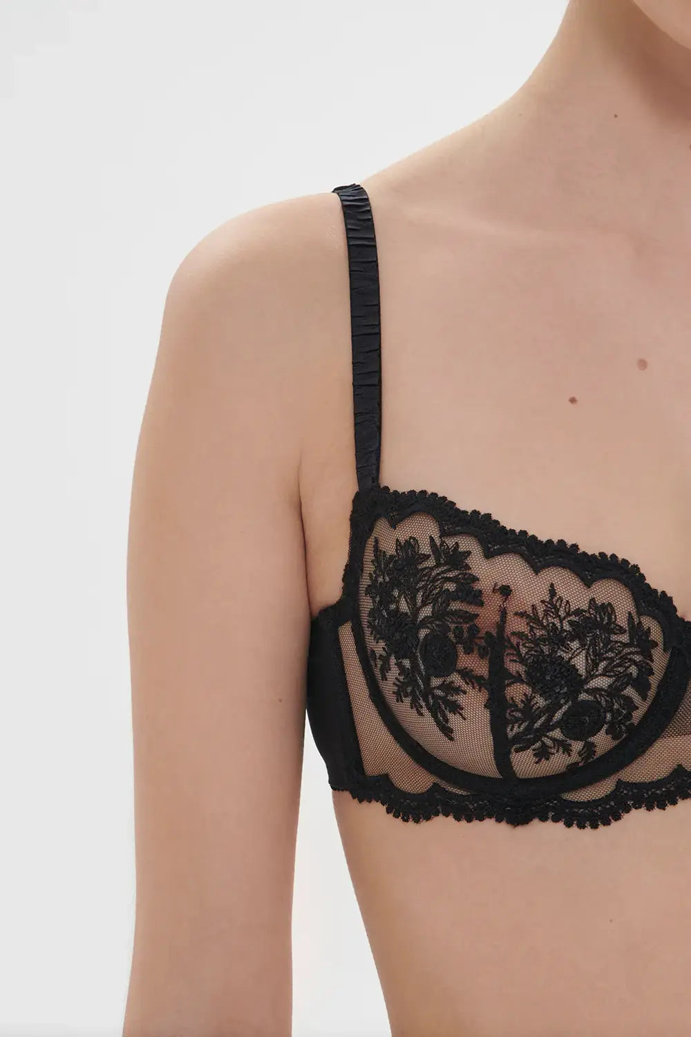 Simone Perele Intrigue sheer demi in black, close-up on a model on a white background.