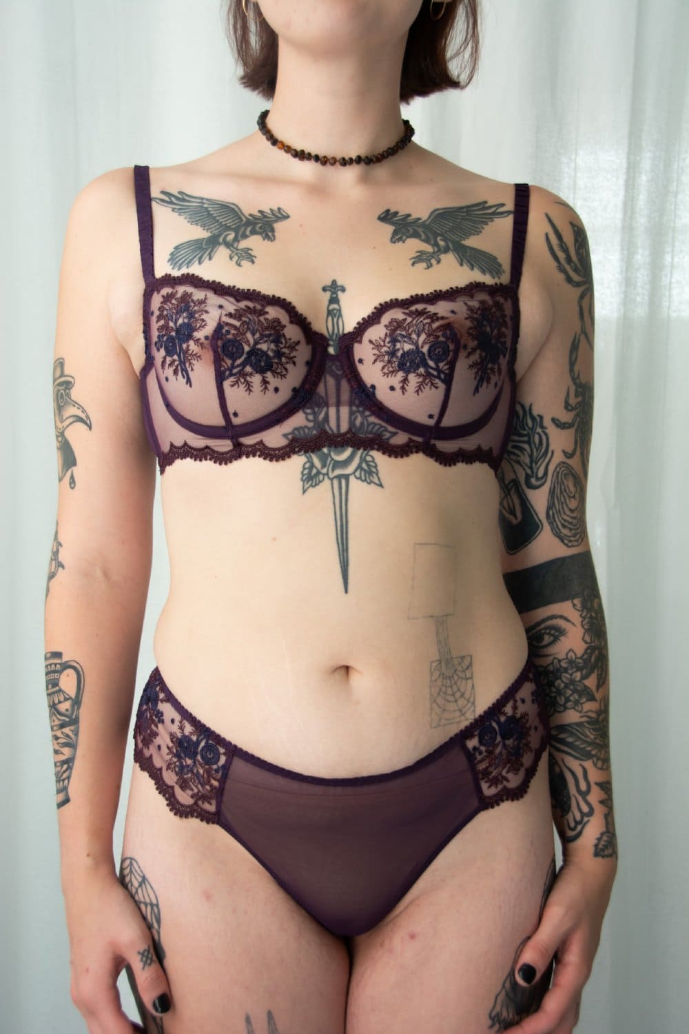 Simone Perele Intrigue sheer demi in fig, front view on a model, close-up.