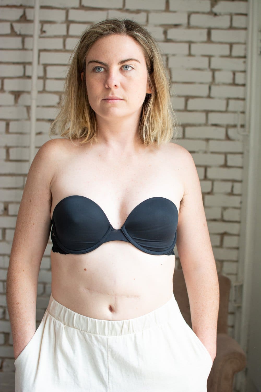 Skarlett blue goddess multiway strapless bra in black, front view on a model, close-up.
