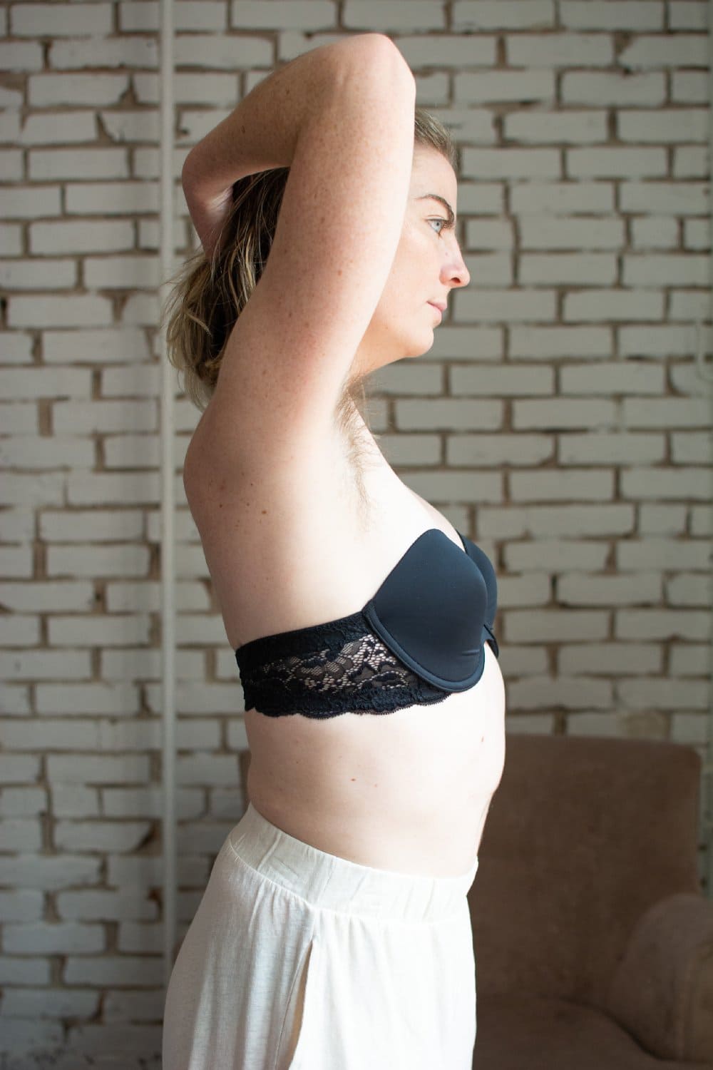 Skarlett blue goddess multiway strapless bra in black, side view on a model, close-up.