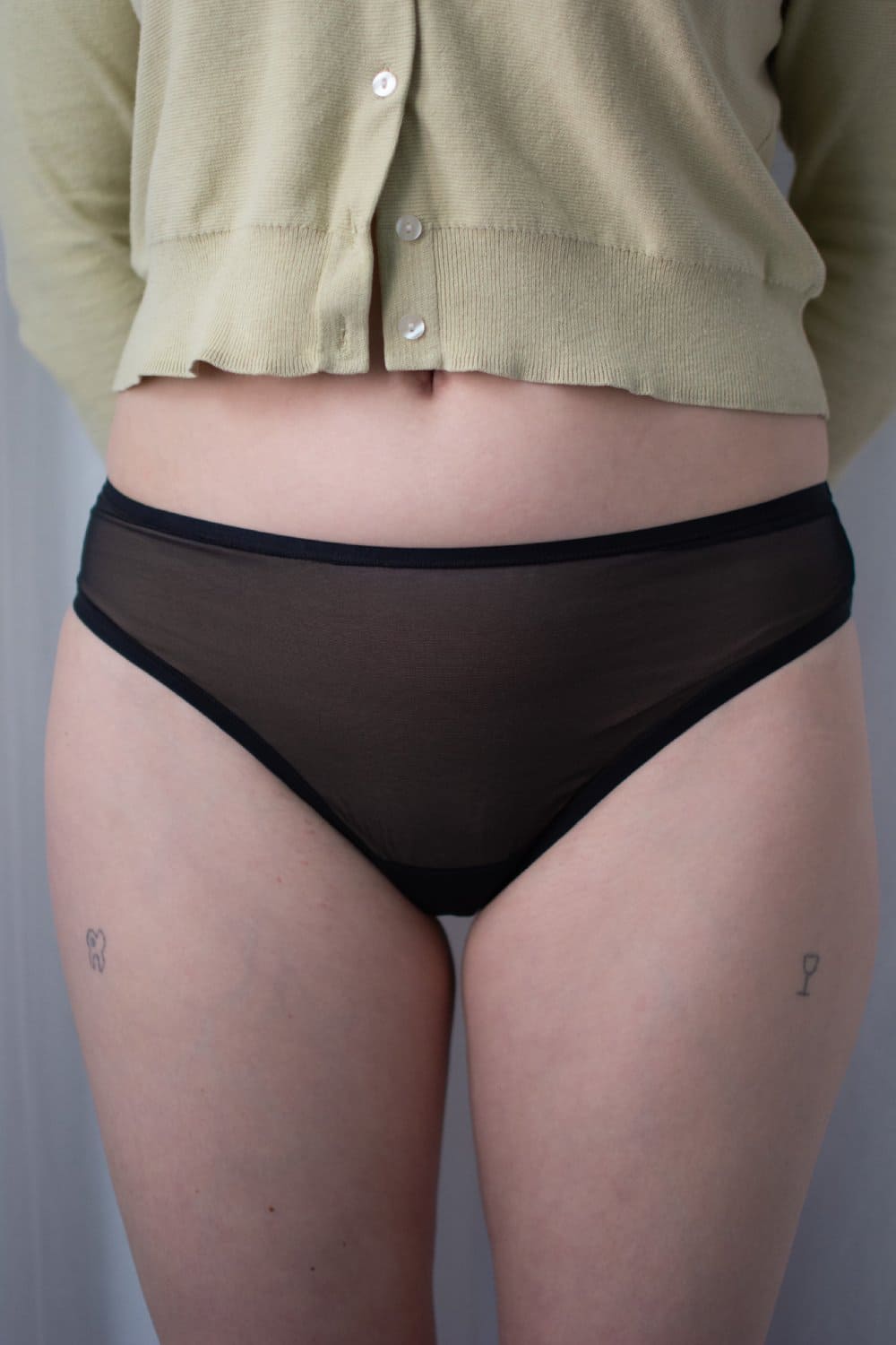 Skarlett blue spellbound nylon thong in black, front view on a model, close-up.
