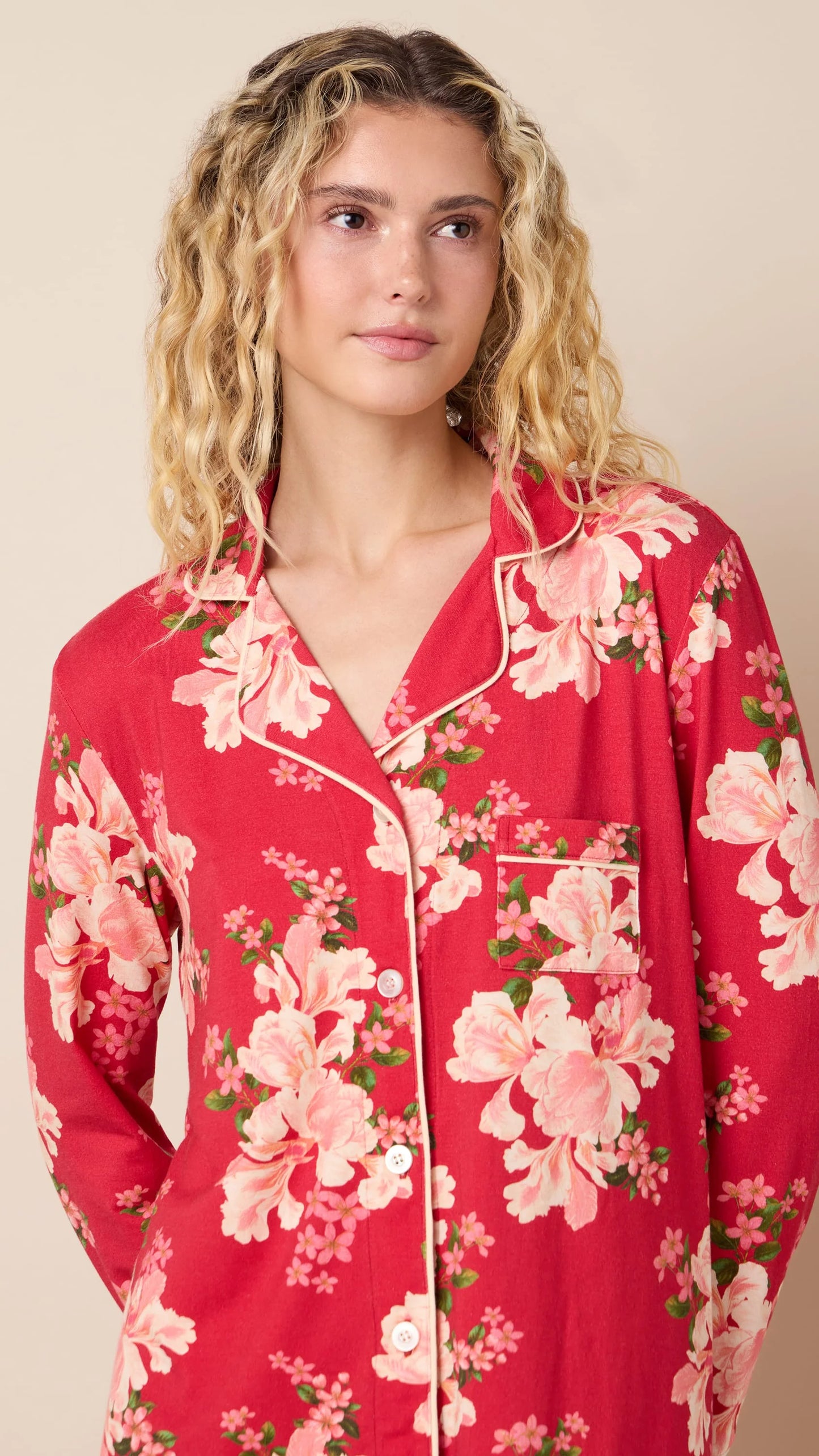 model wearing ref floral pajamas against a neutral background