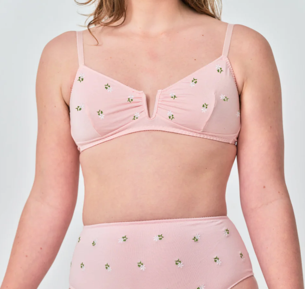 woman wearing pink with flowers on white background