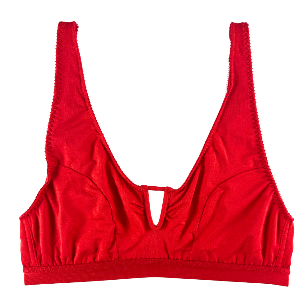 A bright red bralette with wide shoulder straps, a deep V-neckline, and a small cutout at the center front, shown flat against a solid white background.