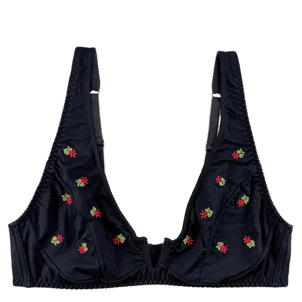 Black bra with red floral embroidery on a white background.