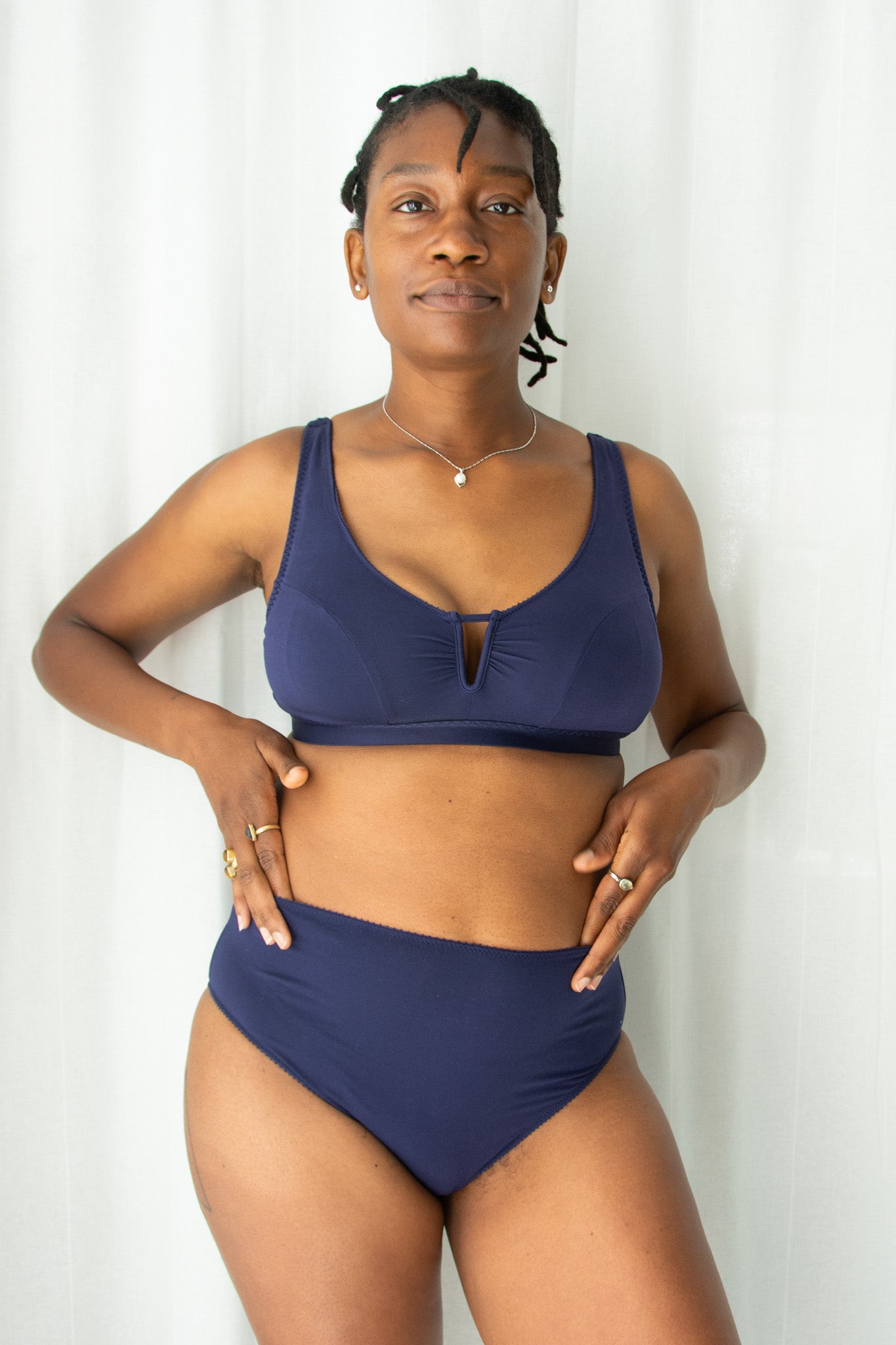 Woman wearing a blue bikini against a white background