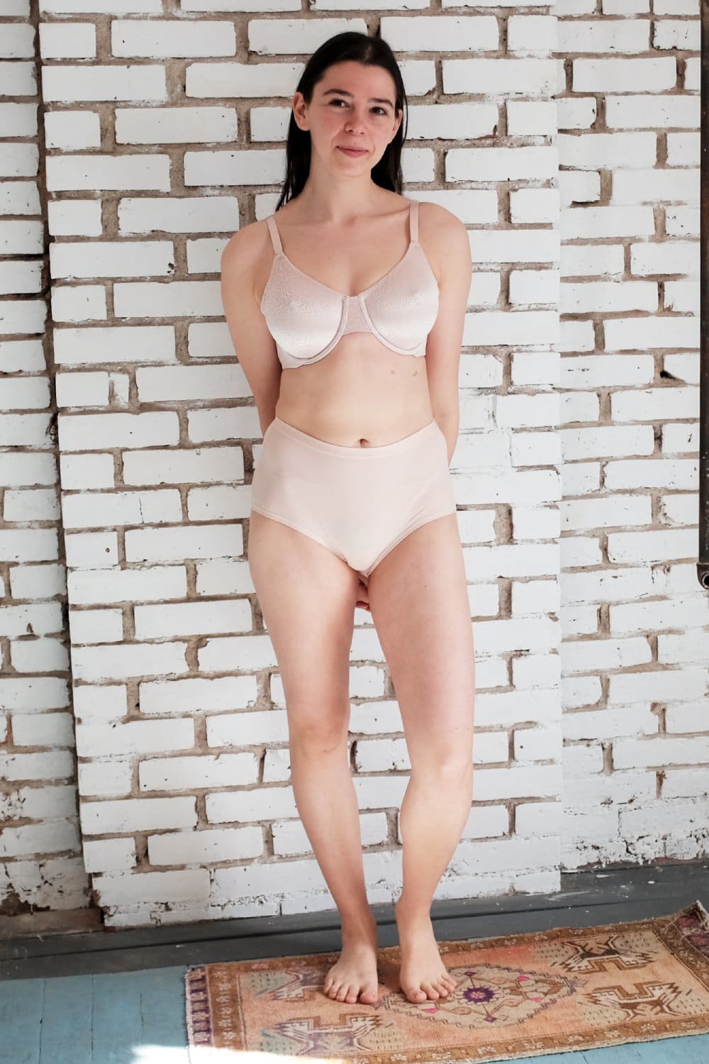 Wacoal Back Appeal full cup bra in rose dust, full-length view on a model against a brick wall.
