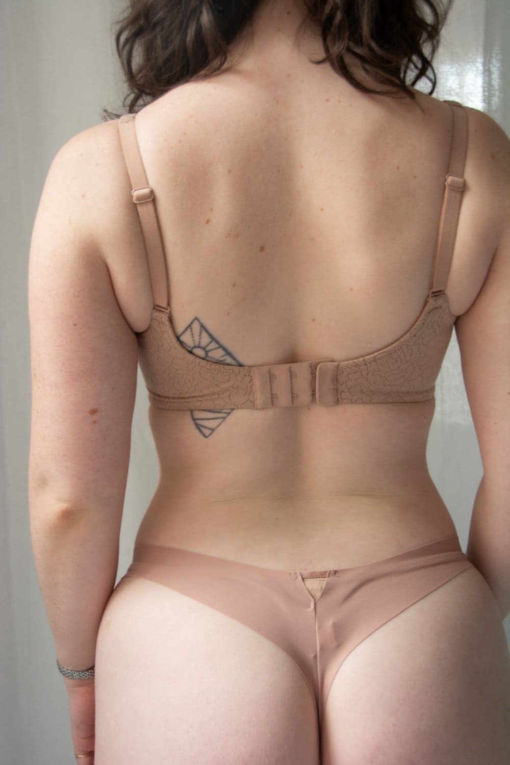 Wacoal inside job wire-free bra in roebuck, back close-up on a model.