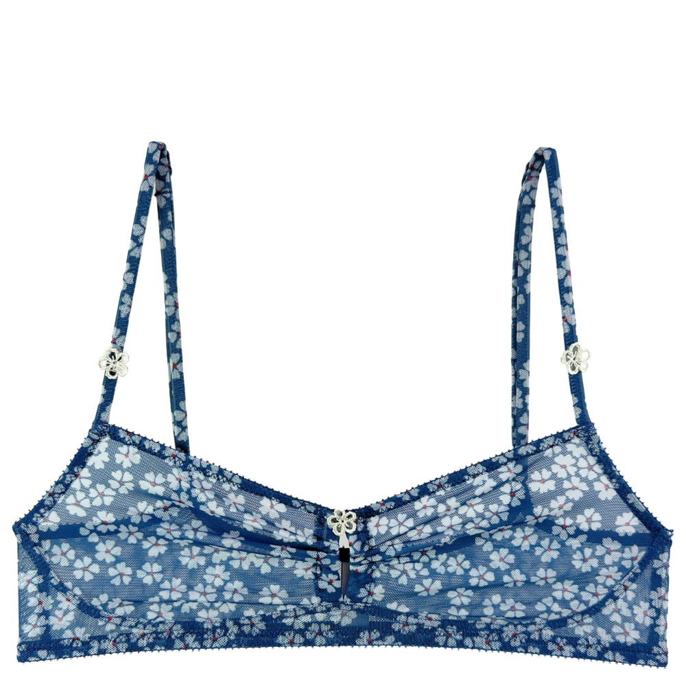 A blue floral lace bralette with thin adjustable straps, a center front zipper, and small decorative silver flower charms on the straps, shown against a plain white background.