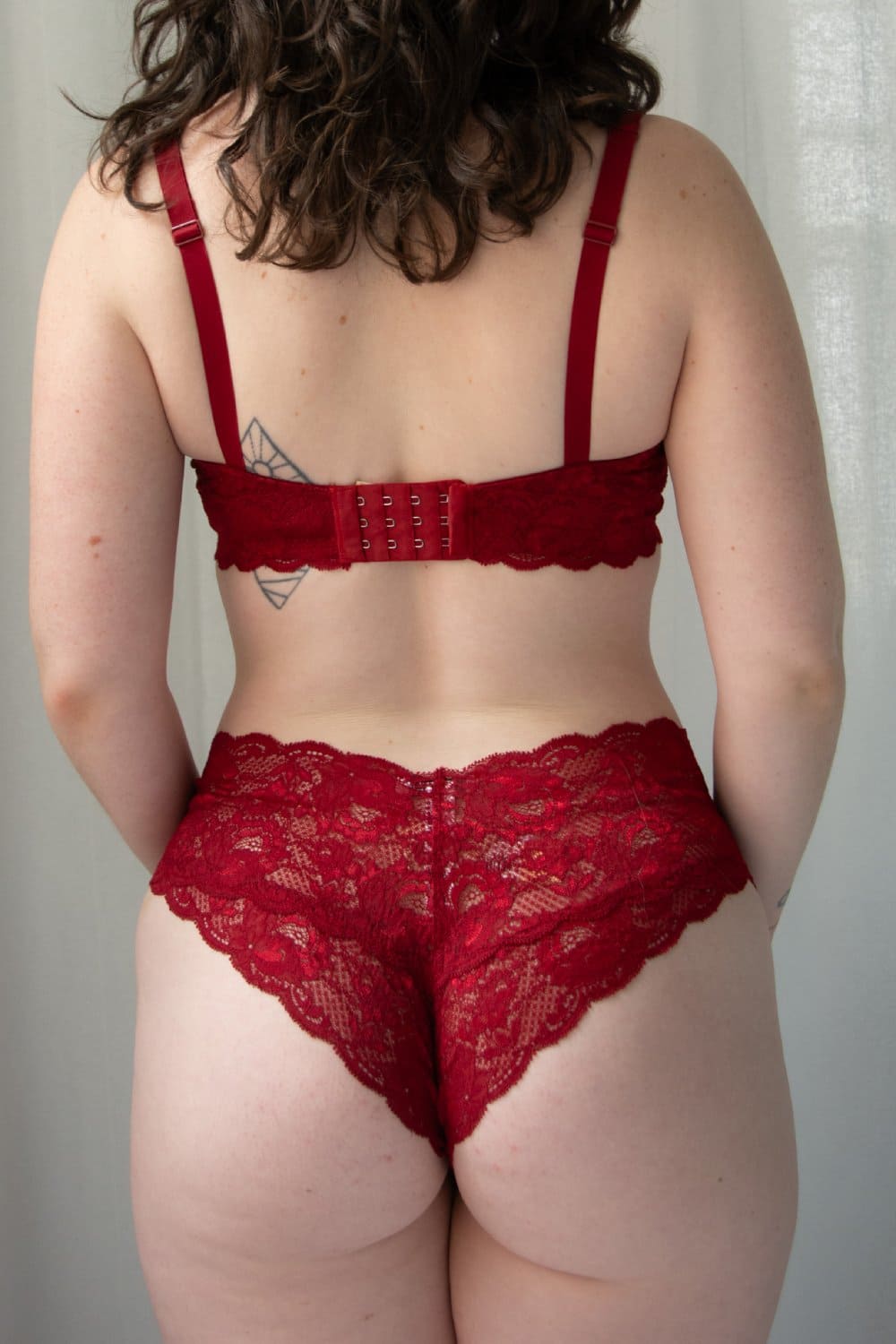 Red lace lingerie set on a neutral background