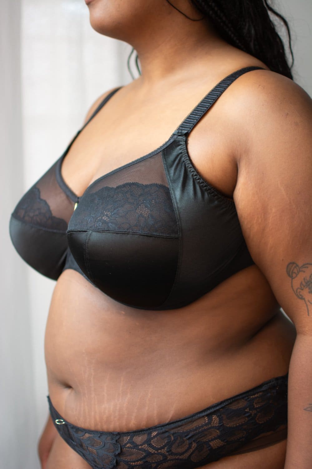 Elomi cate allure underwire bra in black, front-side view on a model, close-up.