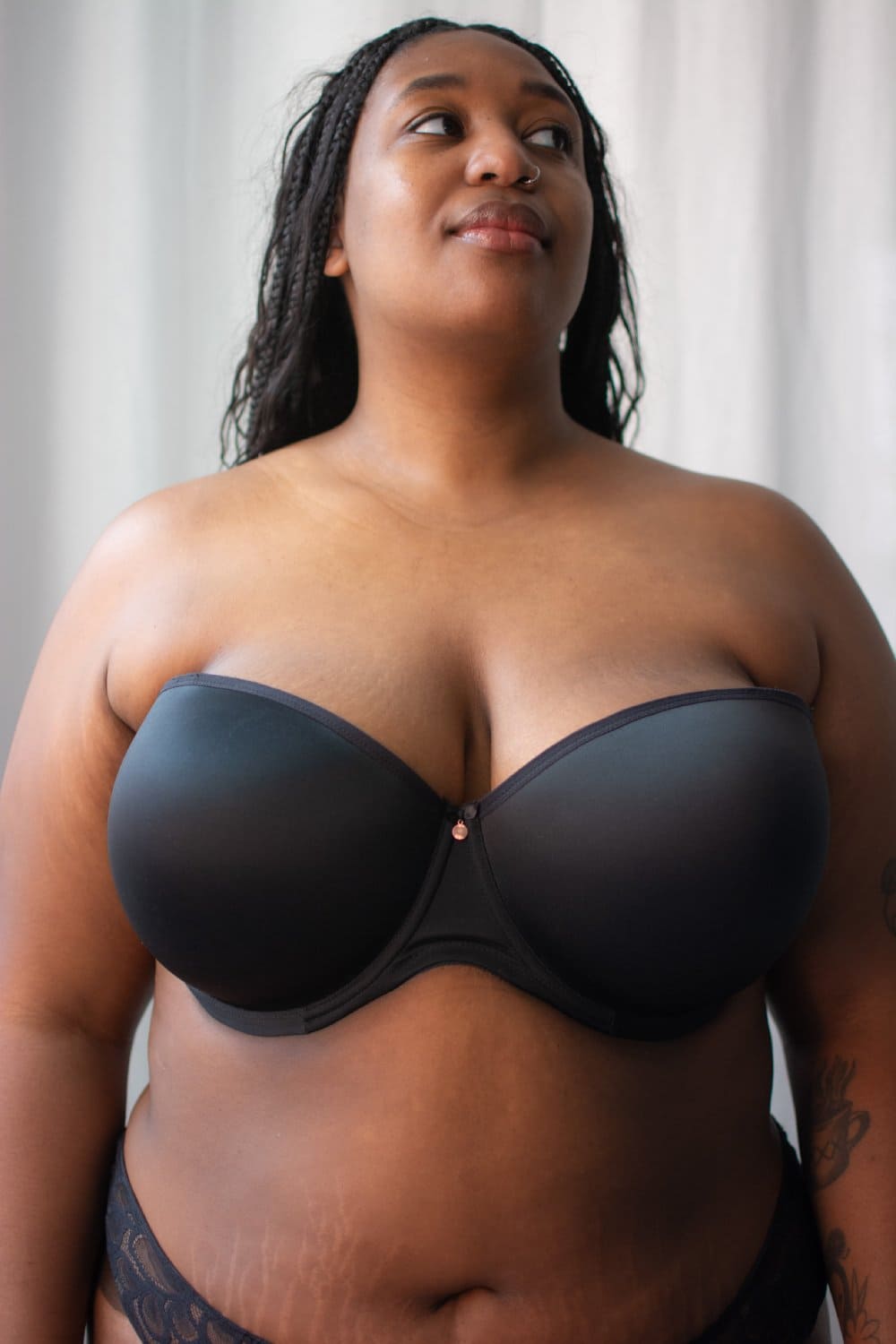 Elomi smooth underwire moulded strapless bra in black, front view on a model.