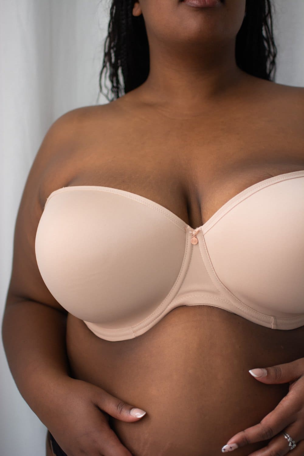 Elomi smooth underwire moulded strapless bra in sahara beige on a model front view, close-up.