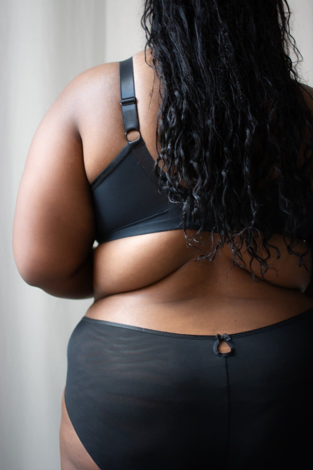 Elomi teagan plunge bra in rainbow, back view on a model, close-up.