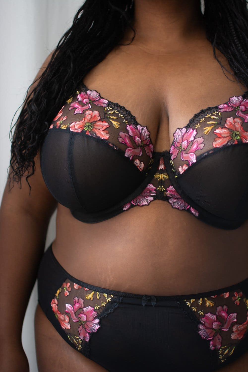 Elomi teagan plunge bra in rainbow, front view on a model, close-up.