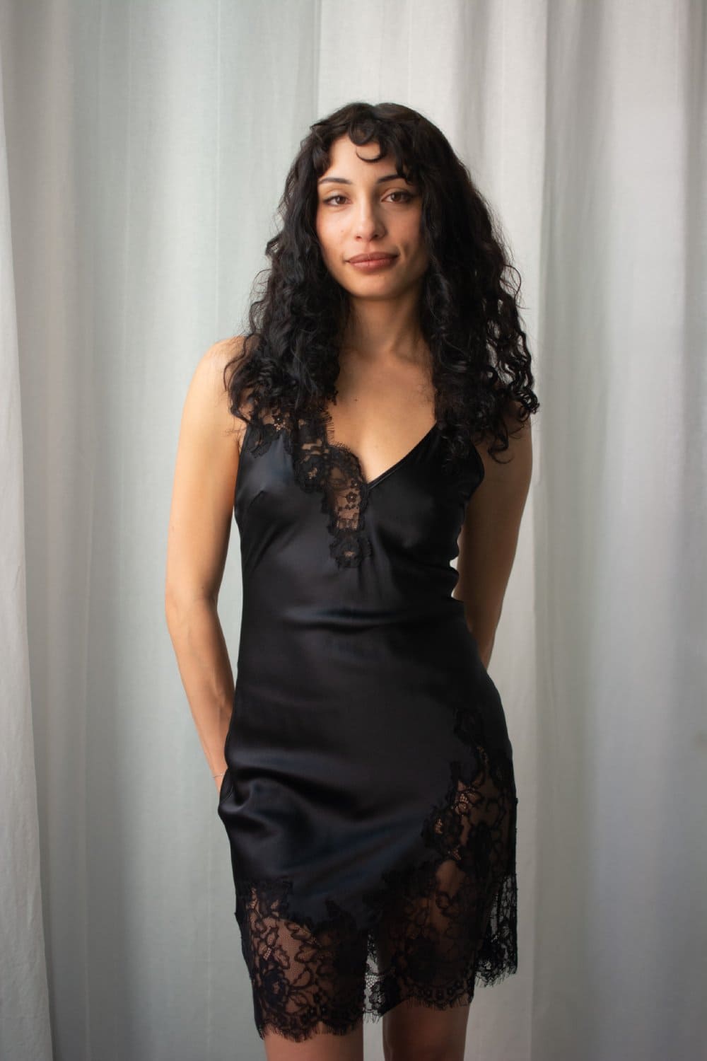 Fleur du mal juliet lace mini slip in black, front view on a model.