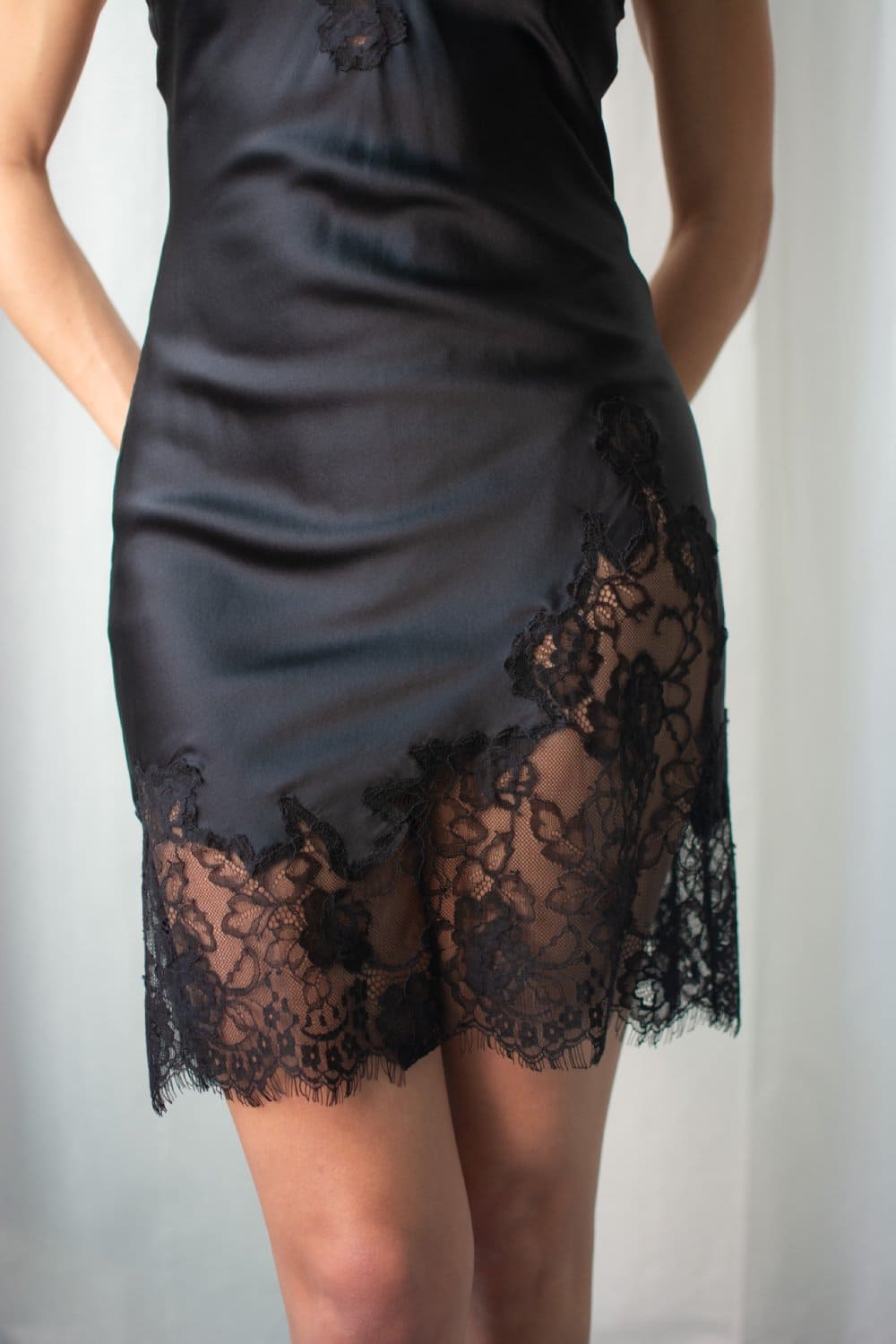 Fleur du mal juliet lace mini slip in black, close-up front view on a model.
