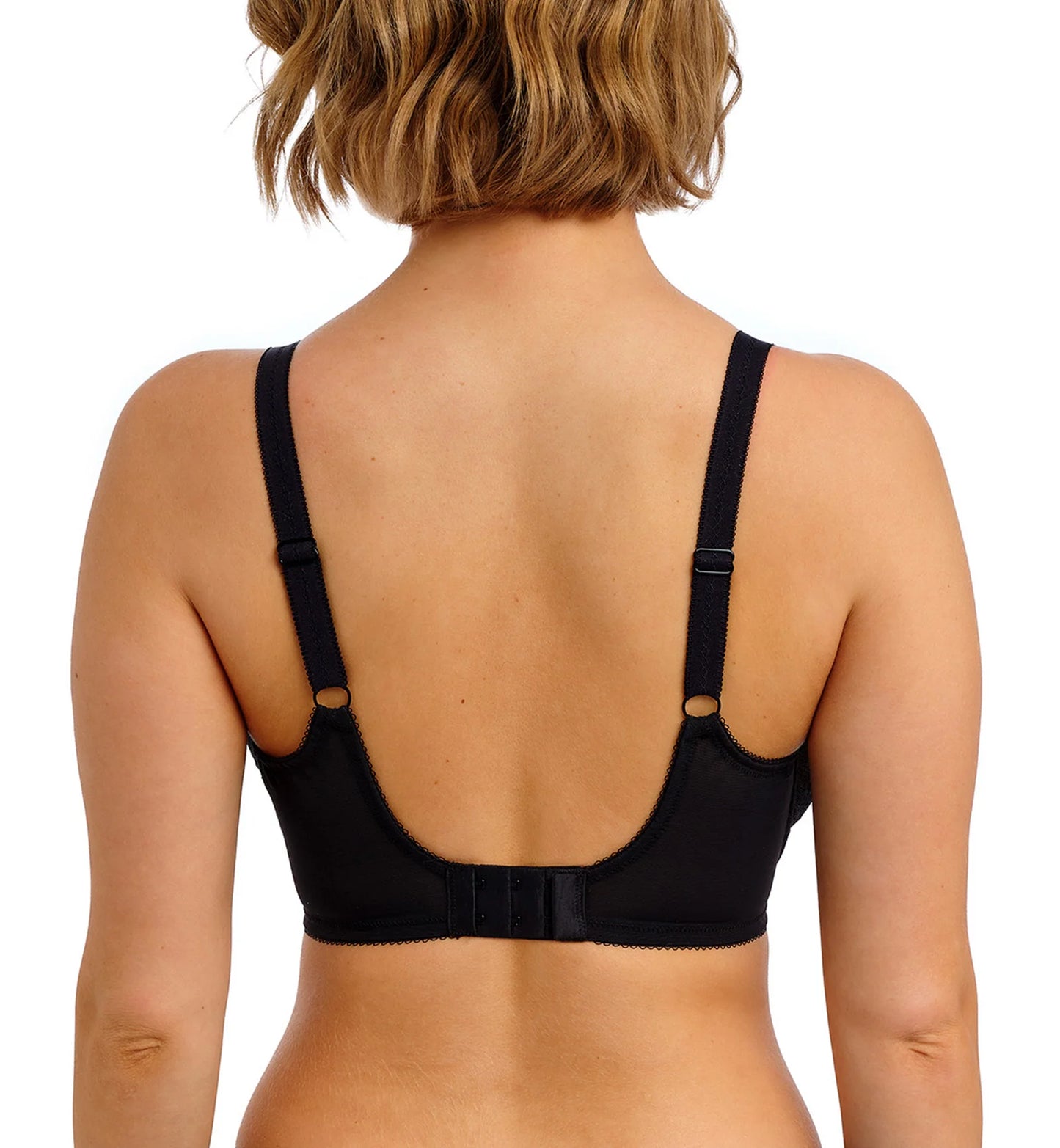 The back of a black bra with a low back, 2 hook closures, and adjustable straps on a model. 