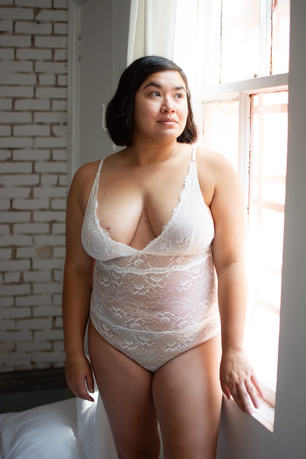 Samantha chang all lace bodysuit in white, front view on a model.